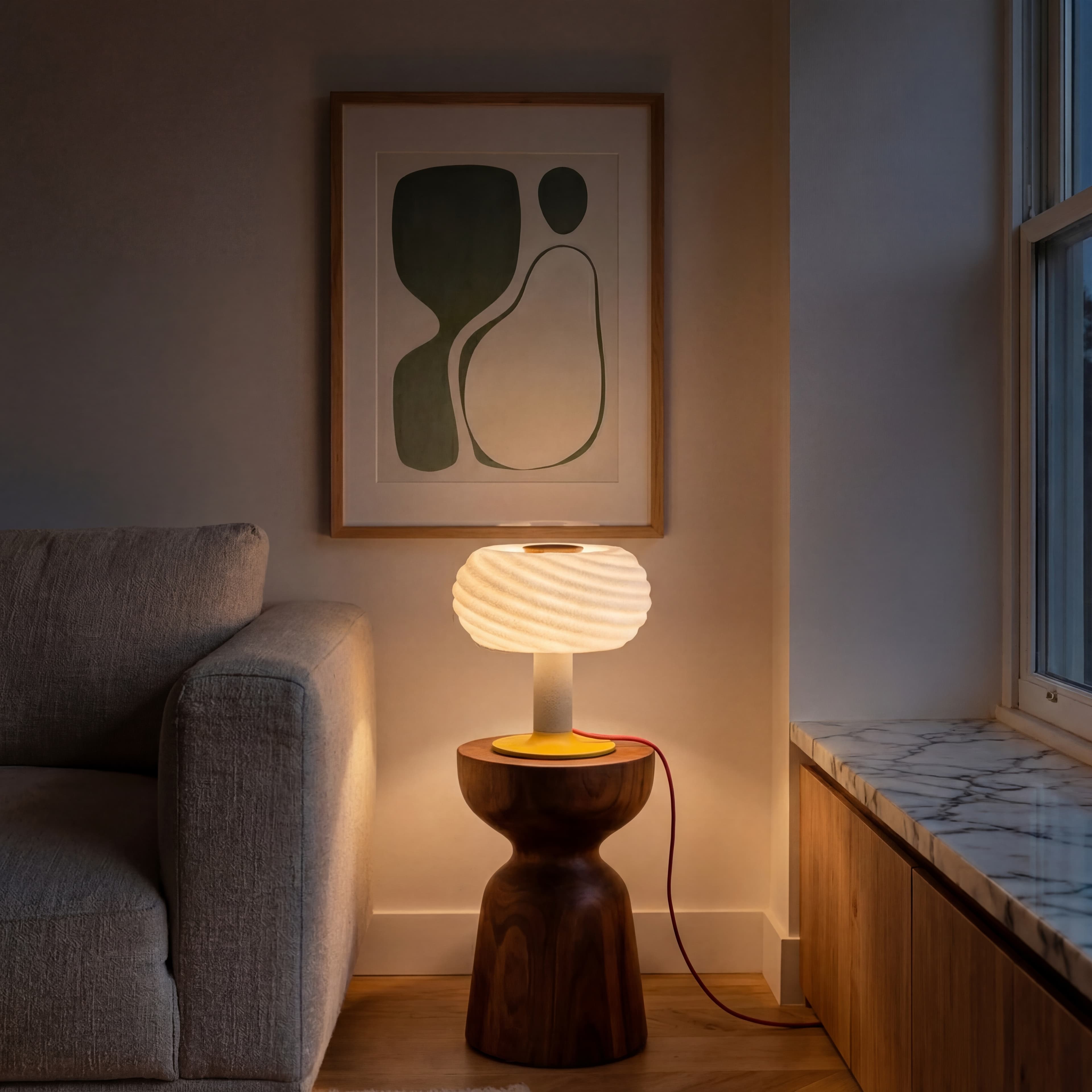 Warm ambient lighting from the Mira wavy lamp on a bedside nightstand