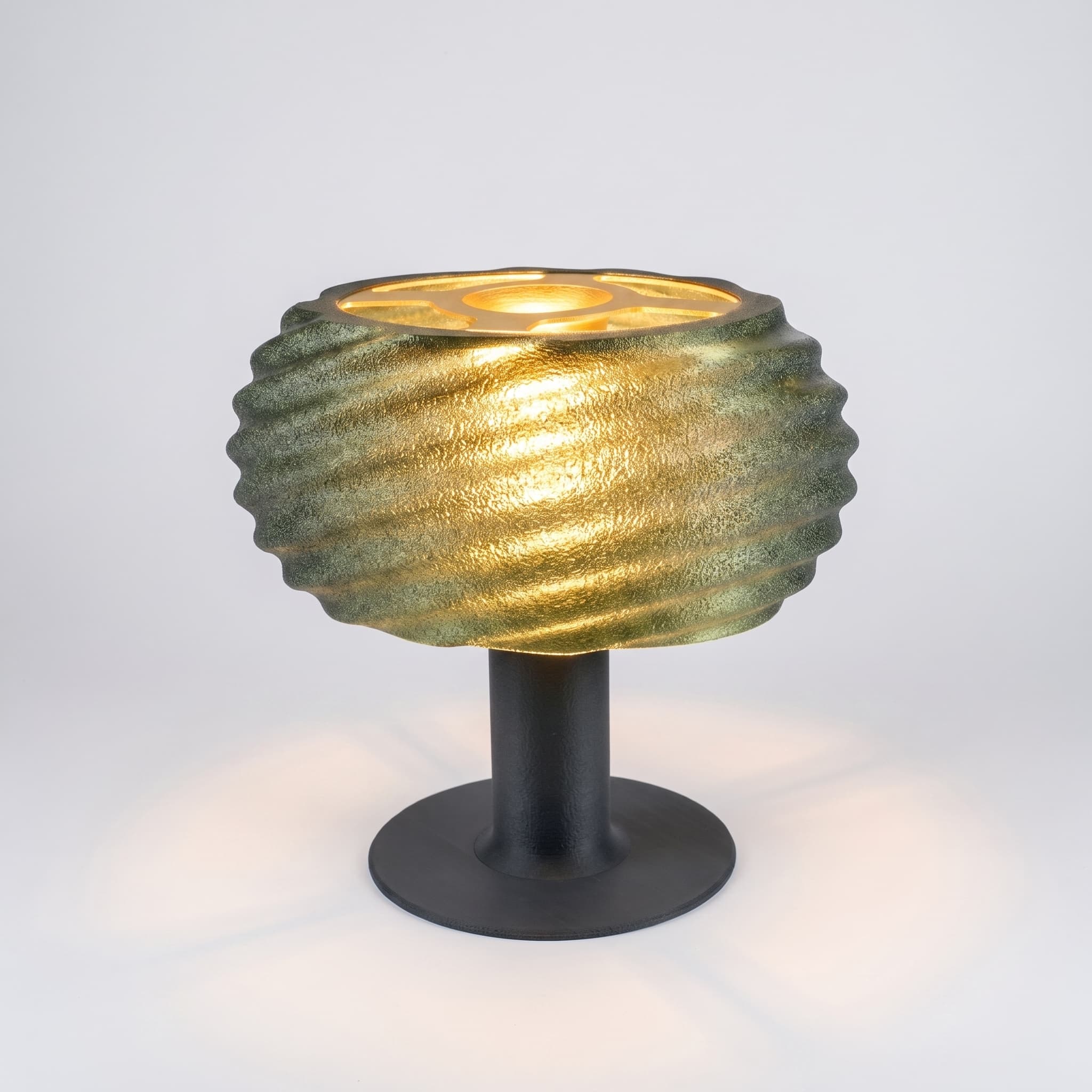 Close-up of Mira wave lamp texture with green spiral diffuser and charcoal base
